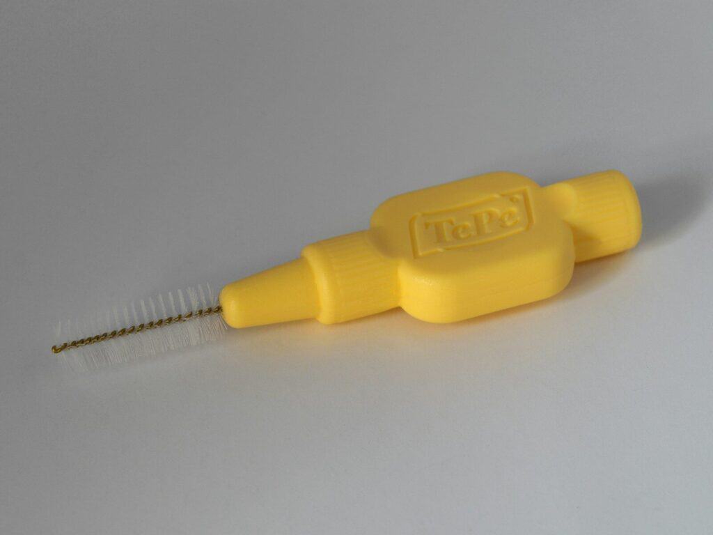 yellow plastic handle on white table