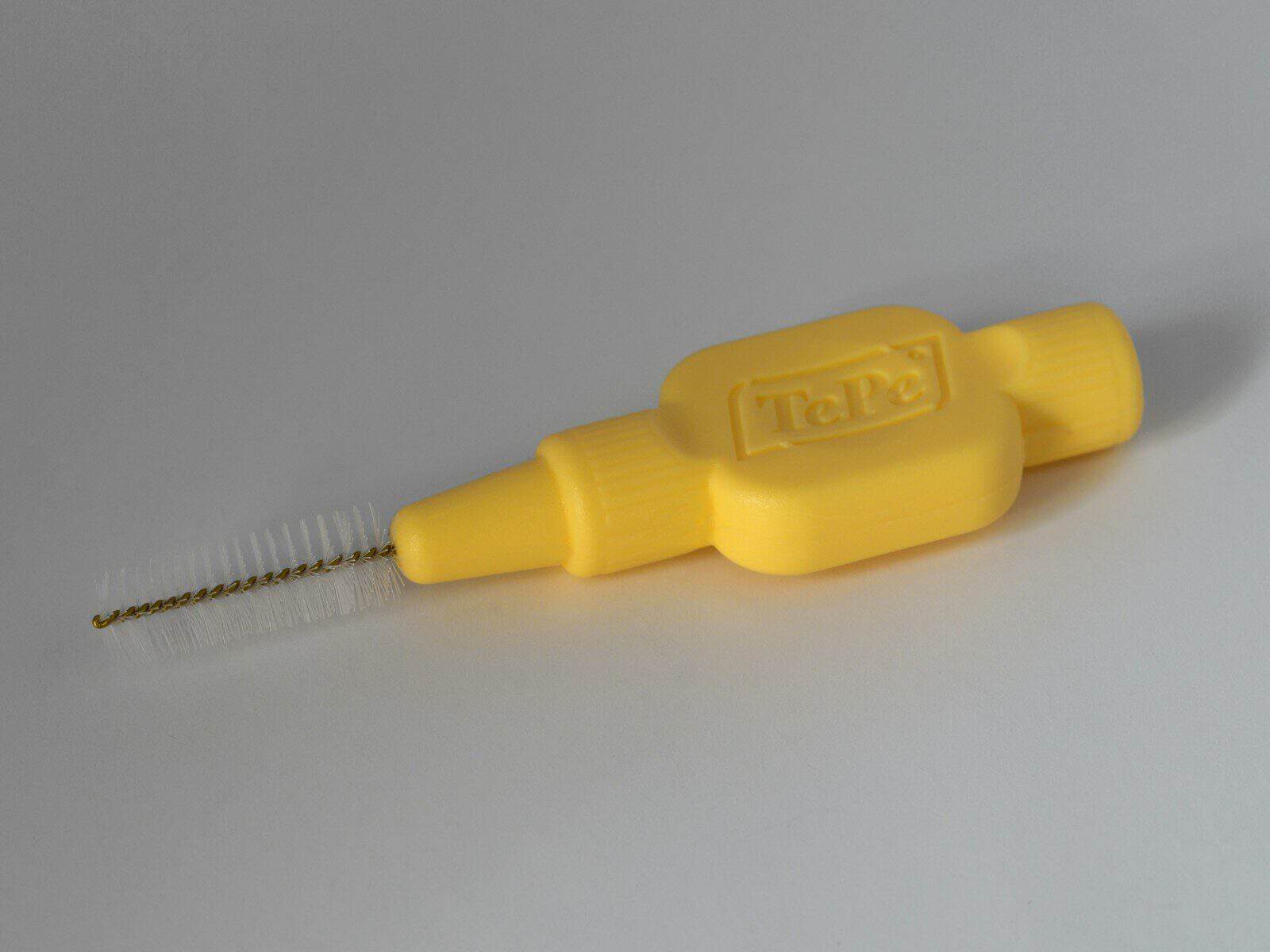 yellow plastic handle on white table